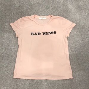 Light pink “bad news” cropped t-shirt